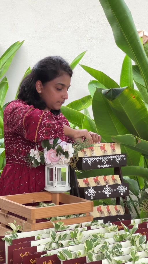 Sugashnie, founder of Greenygift, preparing plant gifts at an event